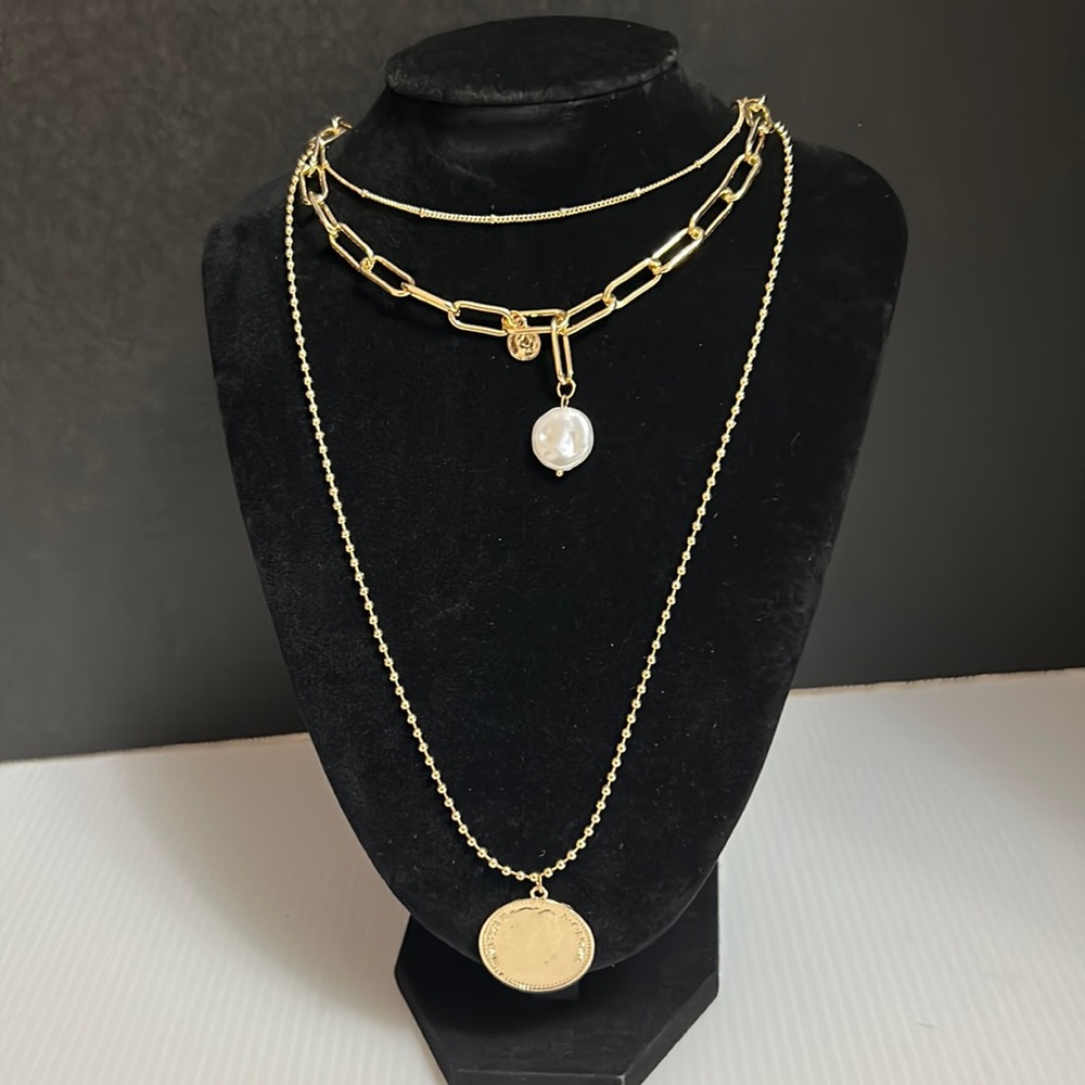 Three layer gold necklace with pearled and coin charms